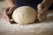 Cropped image of woman shaping bread dough — Stock Photo