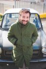 Portrait of mid adult man leaning on vintage car — Stock Photo