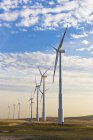 Turbinas eólicas no campo com céu azul nublado — Fotografia de Stock