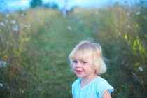 Portrait of young girl in field — Stock Photo