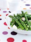 Close up shot of plate with asparagus and peas — Stock Photo