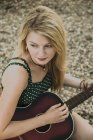 Junge Frau spielt Gitarre, hoher Winkel — Stockfoto