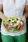 Woman holding bowl of salad — Stock Photo