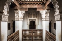 Varanda de madeira e pilares de mármore em Ben Youssef Madrasa, Marrakech, Marrocos — Fotografia de Stock