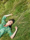 Frau legt sich auf ein Feld — Stockfoto