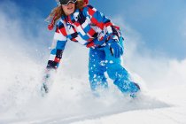 Female snowboarder in action — Stock Photo