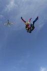 Team of two female skydivers in head down position over Buttwil, Luzern, Switzerland — Stock Photo