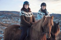Women riding horses outdoors — Stock Photo