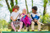 Children playing dress up outdoors — Stock Photo