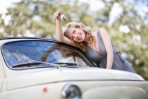 Девушка держит ключи от машины в руке — стоковое фото