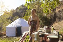 Young woman preparing food whilst glamping, Sierra Nevada, Andalucia Granada, Spain — Stock Photo