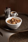 Bowl of cereals with cup of coffee on wooden tray — Stock Photo