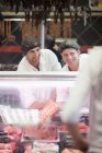 Male butchers working on counter — Stock Photo
