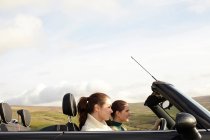 Women driving in rural landscape — Stock Photo