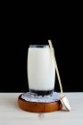Glass of milk with spoon — Stock Photo