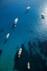 Aerial view of yachts anchored on sea water in sunlight — Stock Photo