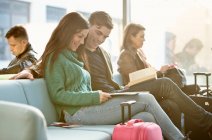 Young couple in departure lounge — Stock Photo