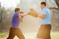 Boxer training with coach outdoors — Stock Photo