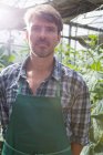 Portrait of organic farmer in greenhouse — Stock Photo