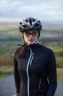 Cyclist standing on rural road — Stock Photo