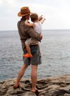 Father holding son outdoors — Stock Photo