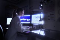 Scientist looking at images from SEM microscope — Stock Photo