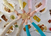 Overhead view of people sharing at table — Stock Photo