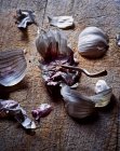 Garlic cloves and skin on wooden board — Stock Photo