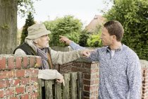 Senior man and mid adult man arguing — Stock Photo