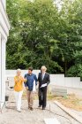 Full length front view of couple discussing housing redevelopment with architect — Stock Photo