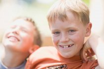 Close up of boys smiling face outdoors — Stock Photo