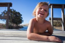 Portrait of boy on pier, smiling — Stock Photo
