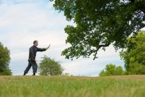 Man performing Tai Chi in countryside — Stock Photo