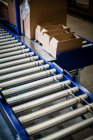 Conveyor transporter with carton boxes — Stock Photo