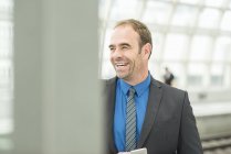 Businessman in suit laughing while looking away — Stock Photo
