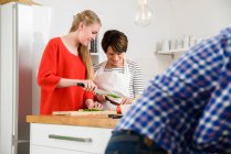 Mother and daughter preparing food in kitchen — Stock Photo