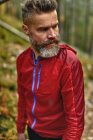 Portrait of handsome bearded man in forest — Stock Photo