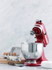 Kitchen mixer with eggs and butter — Stock Photo
