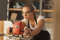 Carpenter working with power tools — Stock Photo