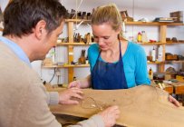Carpenter and assistant working in shop, selective focus — Stock Photo