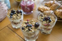 Homemade granola with berries in glasses on table — Stock Photo