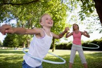 Mother and daughter with hula hoops — Stock Photo