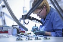 Female worker assembling electronics in electronics factory — Stock Photo