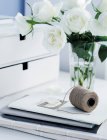Roses and folders on office table — Stock Photo