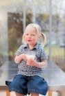 Toddler girl holding glass of milk — Stock Photo