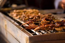 Grilled octopus at street cart — Stock Photo
