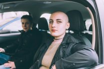 Portrait of young lesbian couple sitting in car — Stock Photo