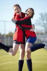 Team members hugging on field — Stock Photo