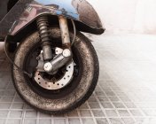 Close-up view of old dirty moped wheel with tire — Stock Photo