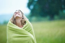 Женщина, завернутая в одеяло на улице — стоковое фото